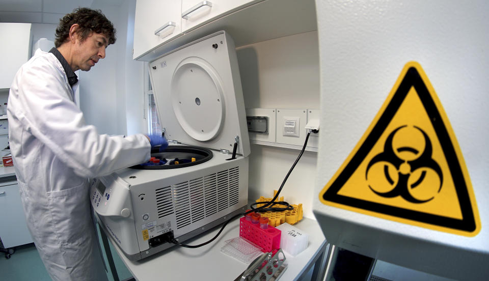 Christian Drosten, director of the institute for virology of Berlin's Charite hospital stands next to a centrifuge after an interview with the Associated Press on his researches on the coronavirus in Berlin, Germany, Tuesday, Jan. 21, 2020. (AP Photo/Michael Sohn)