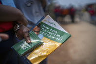 Volunteers go door to door with vaccination information material in Lawley, South Africa, during a visit of local government officials for the launch of the Vooma vaccination program against COVID-19 Friday Dec. 3, 2021. South Africa has accelerated its vaccination campaign a week after the discovery of the omicron variant of the coronavirus. (AP Photo/Jerome Delay)