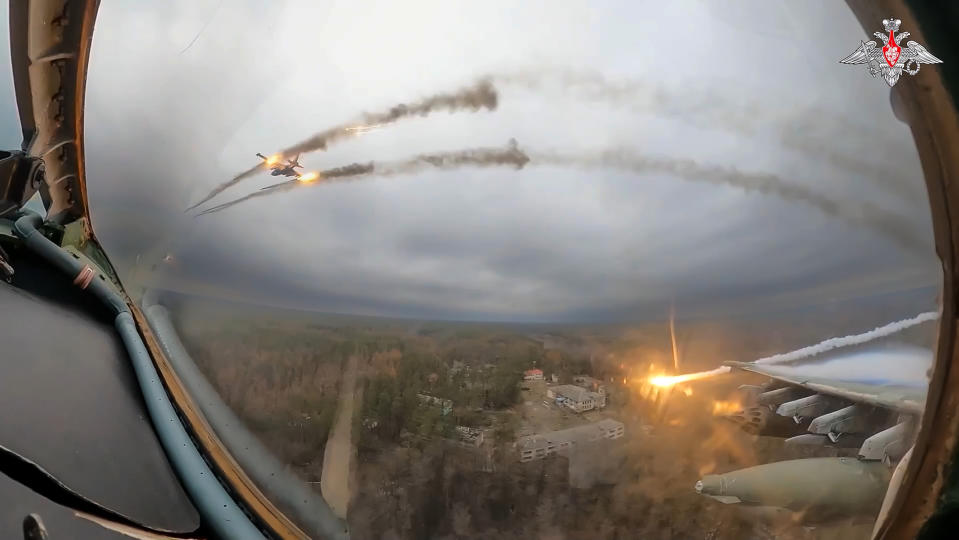 In this photo taken from video released by the Russian Defense Ministry Press Service on Monday, Jan. 22, 2024, A Su-25 ground attack jet of the Russian air force is seen from the cockpit of another such aircraft as they fire rockets on a mission over Ukraine. (Russian Defense Ministry Press Service via AP)