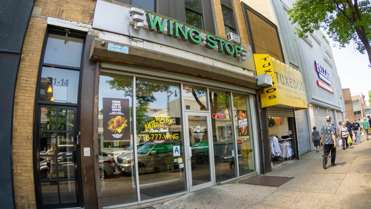 New York NY/USA-May 27, 2019 WingStop fast food on busy Steinway Street in the Astoria neighborhood of Queens - Image.