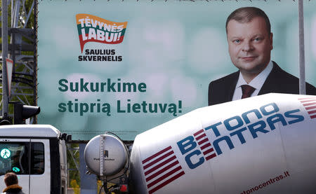 A truck drives past Lithuanian Presidential candidate's Saulius Skvernelis election campaign placard in Vilnius, Lithuania May 9, 2019. REUTERS/Ints Kalnins