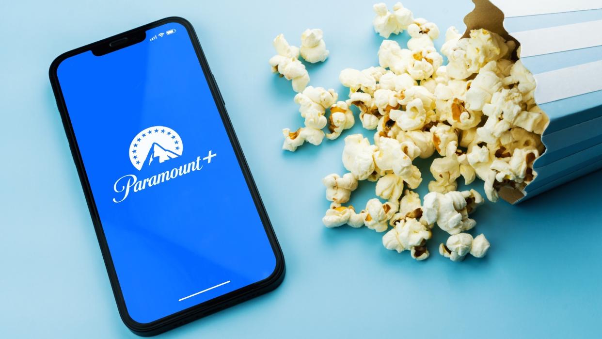  Paramount Plus app on a phone next to popcorn. 