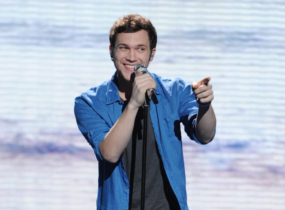 FILE - In this May 9, 2012 file photo provided by Fox, contestant Phillip Phillips performs on the singing competition series "American Idol," in Los Angeles. With the eleventh season finale of "American Idol" just a week away, many fans of the Fox talent contest aren't wondering who will capture the title, but whether sassy 16-year-old diva-in-training Jessica Sanchez or booming 20-year-old vocal showstopper Joshua Ledet would even have the votes to beat bluesy 21-year-old front-runner Phillip Phillips. (AP Photo/Fox, Michael Becker, File)