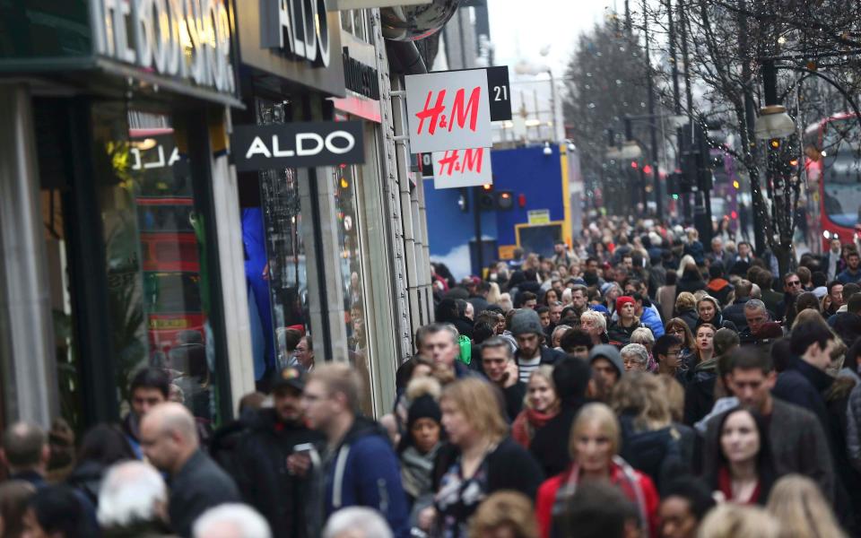 Shoppers walking along a busy Oxford Street in London