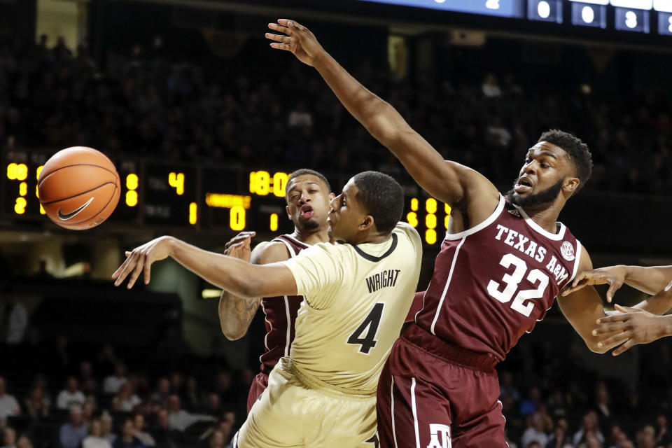 Vanderbilt guard Jordan Wright (4) passes the ball away from Texas A&M forward Josh Nebo (32) in the first half of an NCAA college basketball game Saturday, Jan. 11, 2020, in Nashville, Tenn. (AP Photo/Mark Humphrey)