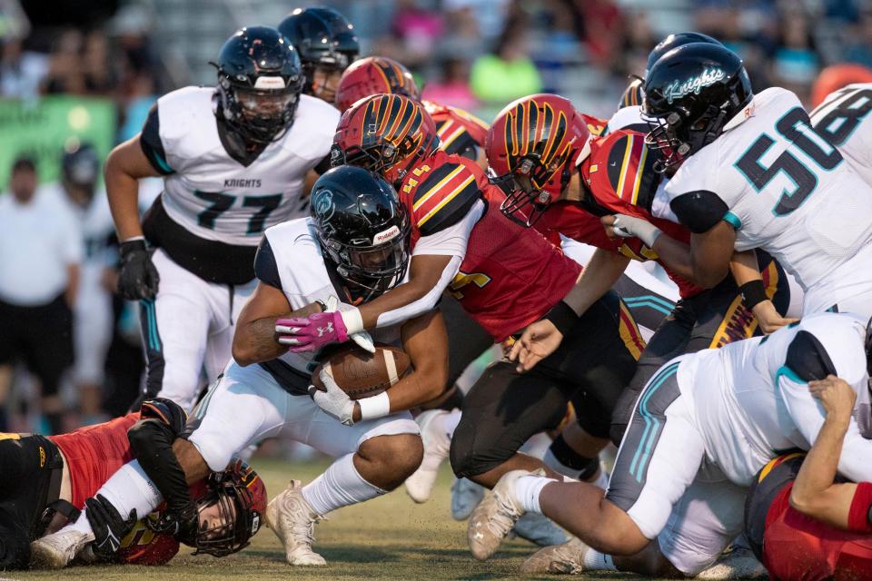 Organ Mountain defensive back Fabian Lozoya runs the ball during a high school football game on Friday, Sept. 23, 2022, at the Field of Dreams. 