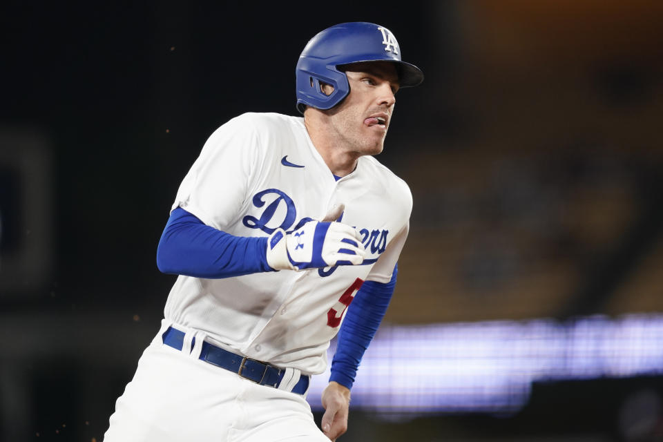 Los Angeles Dodgers' Freddie Freeman runs to score off a single hit by designated hitter J.D Martinez during the ninth inning of a baseball game against the San Diego Padres, Monday, Sept. 11, 2023, in Los Angeles. (AP Photo/Ryan Sun)