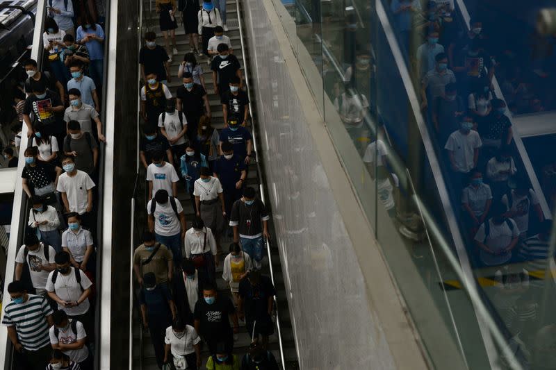 People wearing face masks walk inside a subway station during morning rush hour, following an outbreak of the novel coronavirus disease (COVID-19), in Beijing