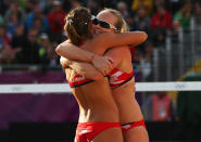 LONDON, ENGLAND - JULY 29: Zara Dampney and Shauna Mullin of Great Britain celebrate during the Women's Beach Volleyball Preliminary match between Great Britain and Canada on Day 2 of the London 2012 Olympic Games at Horse Guards Parade on July 29, 2012 in London, England. (Photo by Ryan Pierse/Getty Images)