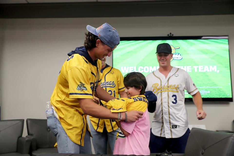 Noah Bridges helps Mark "Swaggy" Lane put on his new Savannah Bananas jersey that he will be wearing during the August 3 game at Historic Grayson Stadium in Savannah Georgia. "Swaggy" received the jersey on Wednesday, August 2, 2023 after signing his contract to paly for the Bananas as a part of his wish with the Make a Wish Foundation.