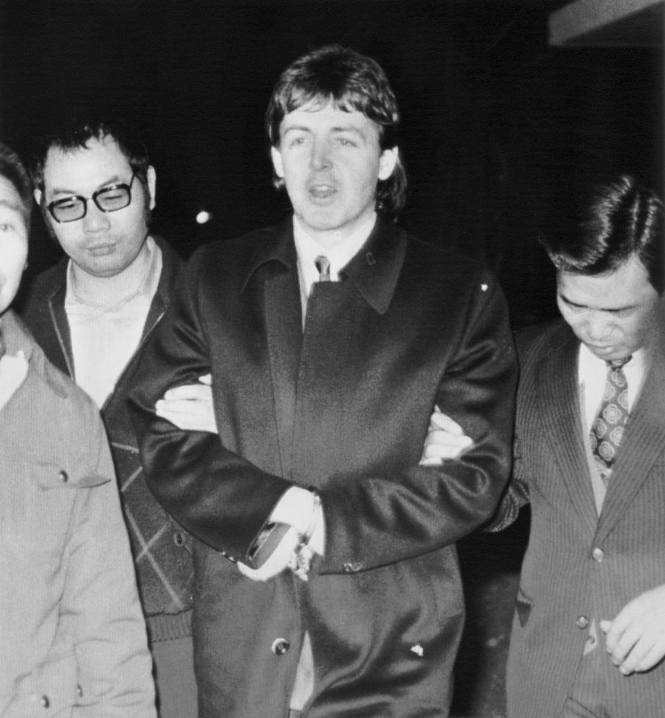(Original Caption) Flanked by police officers, handcuffed Paul McCartney, a member of the defunct Beatles pop group, after arrested 1/16 for allegedly bringing in over 200 grams of marijuana into Japan.