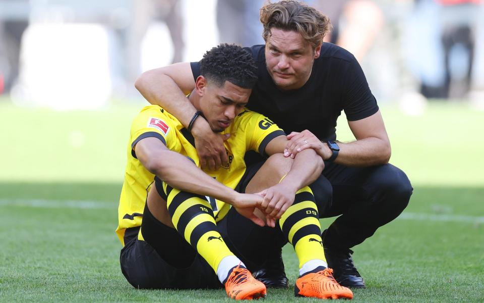 Edin Terzic hugs a seated and dejected Jude Bellingham after Borussia Dortmund draw with FSV Mainz and finish second in the Bundesliga behind Bayern Munich