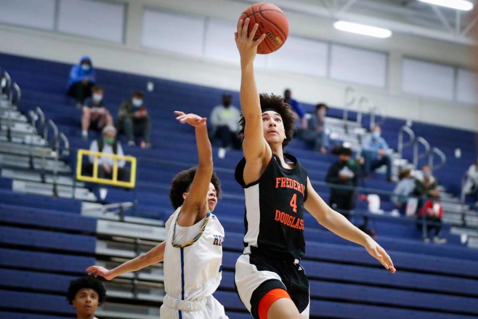 Frederick Douglass’ Kai Simpson (4) shoots over Henry Clay’s Sincere Madison (4) on March 9, 2021. Alex Slitz/Herald-Leader file photo