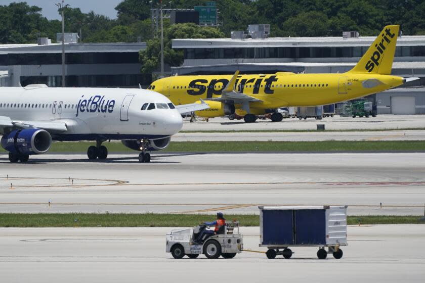 FILE - A JetBlue Airways Airbus A320, left, passes a Spirit Airlines Airbus A320 as it taxis on the runway, July 7, 2022, at the Fort Lauderdale-Hollywood International Airport in Fort Lauderdale, Fla. JetBlue and Spirit Airlines are ending their proposed $3.8 billion combination after a court ruling blocked their merger. JetBlue said Monday, March 4, 2024 that even though both companies still believe in the benefits of a combination, they felt they were unlikely to meet the required closing conditions before the July 24 deadline and mutually agreed that terminating the deal was the best decision for both. (AP Photo/Wilfredo Lee, File)