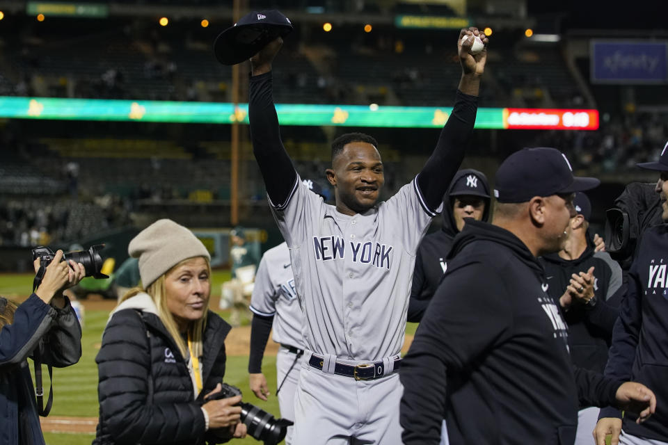 New York Yankees' Domingo Germán, center, celebrates after pitching a perfect game against the Oakland Athletics in a baseball game in Oakland, Calif., Wednesday, June 28, 2023. The Yankees won 11-0. (AP Photo/Godofredo A. Vásquez)
