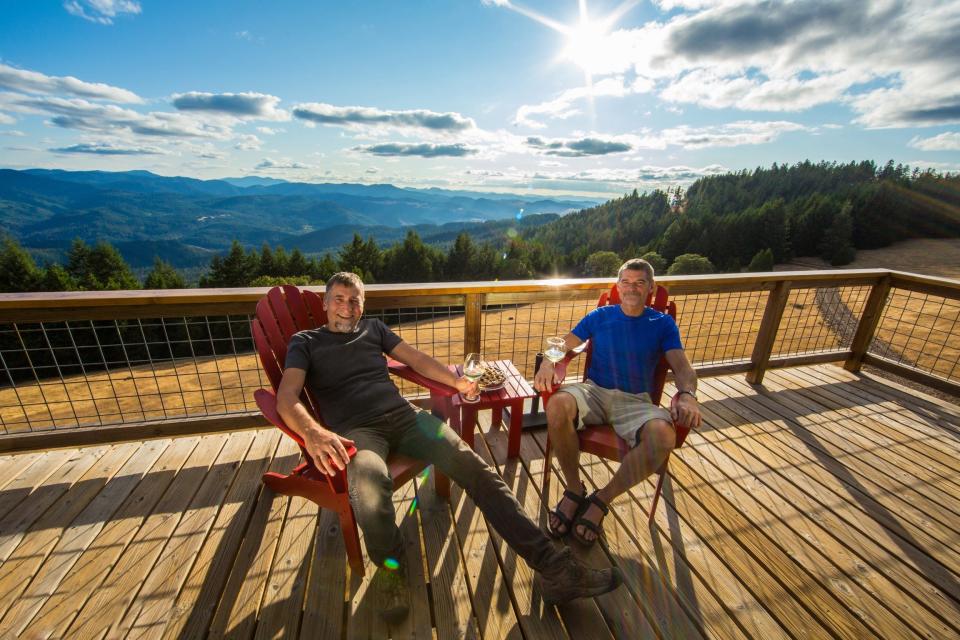 oregon airbnb hosts sitting on porch of tower