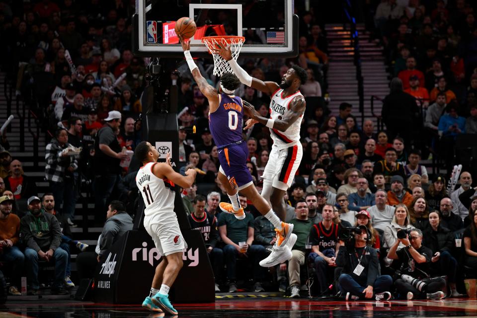 Jordan Goodwin #0 of the Phoenix Suns shoots against Deandre Ayton #2 of the Portland Trail Blazers and Malcolm Brogdon #11 during the second quarter of the game at Moda Center on Dec. 19, 2023 in Portland, Oregon. The Portland Trail Blazers won 109-104. NOTE TO USER: User expressly acknowledges and agrees that, by downloading and/or using this photograph, User is consenting to the terms and conditions of the Getty Images License Agreement. (Photo by Alika Jenner/Getty Images)