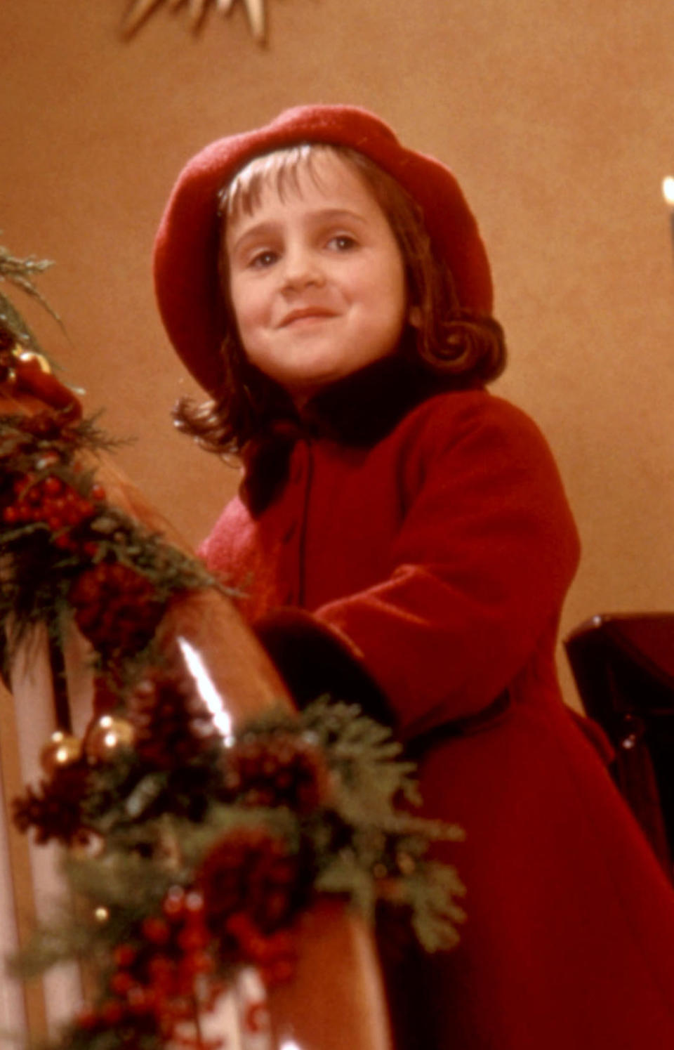 Wilson as a kid, smiling while on a staircase on Christmas morning