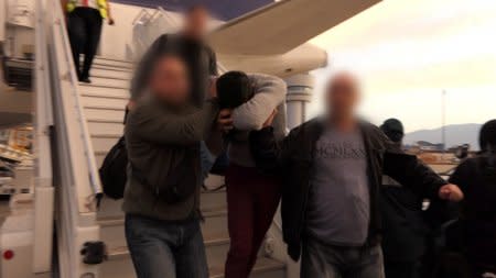 A video grab shows police escorting Severin Krasimirov, 21, who was arrested in Germany over the killing of TV journalist Viktoria Marinova, at Sofia airport, Bulgaria, October 17, 2018.  Bulgarian Interior Ministry/Handout via REUTERS