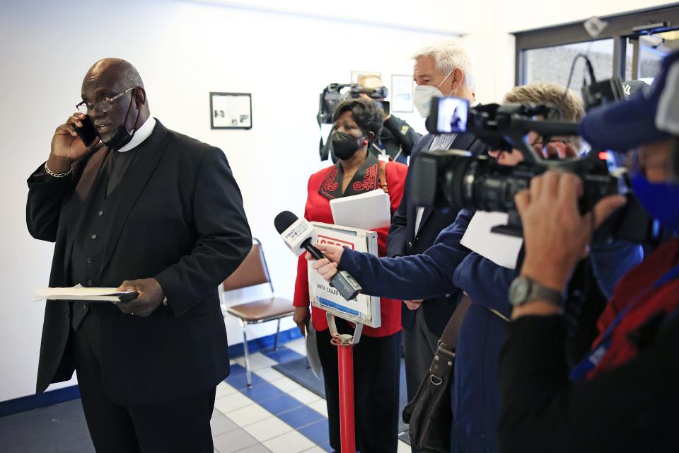 The Rev. Tan Moss (right), co-president of Jacksonville's ICARE, tries to get Sheriff Mike Williams' aide on the phone after being told he is not available. ICARE sought a meeting with Williams to discuss an adult civil citation program for minor offenses and had letters of support.