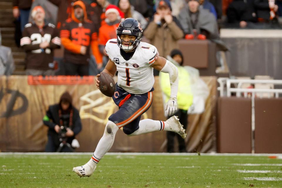 Chicago Bears quarterback Justin Fields (1) runs with the ball during an NFL football game against the Cleveland Browns on Dec. 17, 2023, in Cleveland.