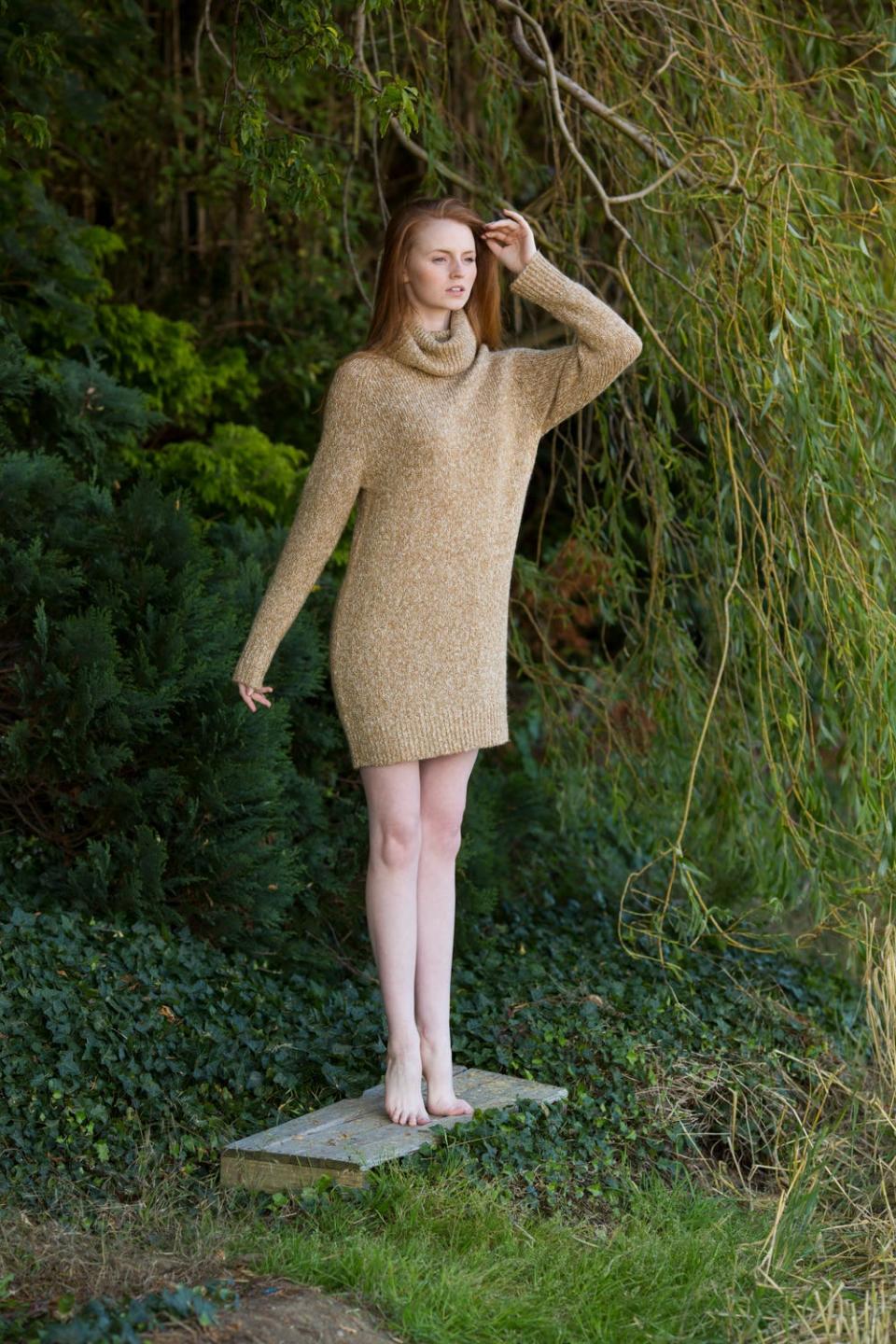 A redheaded model named Sarah Kennedy from Donegal, Ireland, poses in the woods