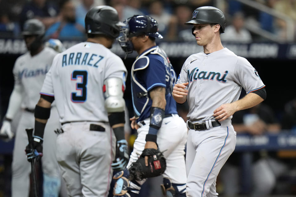 Miami Marlins' Joey Wendle, right, scores on a wild pitch by Tampa Bay Rays starting pitcher Tyler Glasnow during the third inning of a baseball game Tuesday, July 25, 2023, in St. Petersburg, Fla. (AP Photo/Chris O'Meara)