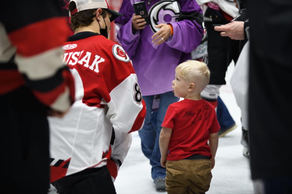 Zack Andrusiak greets a young fan on the ice after the matchup between the Cincinnati Cyclones and the Fort Wayne Komets Friday, Mar. 18, 2022 at Heritage Bank Center.