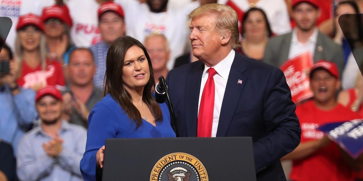 President Donald Trump stands with Sarah Huckabee Sanders, who announced that she is stepping down as the White House press secretary, during his rally where he announced his candidacy for a second presidential term at the Amway Center on June 18, 2019 in Orlando, Florida..