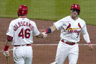 St. Louis Cardinals' Andrew Knizner is congratulated by teammate Paul Goldschmidt (46) after scoring during the fifth inning of a baseball game against the Colorado Rockies Friday, May 7, 2021, in St. Louis. (AP Photo/Jeff Roberson)