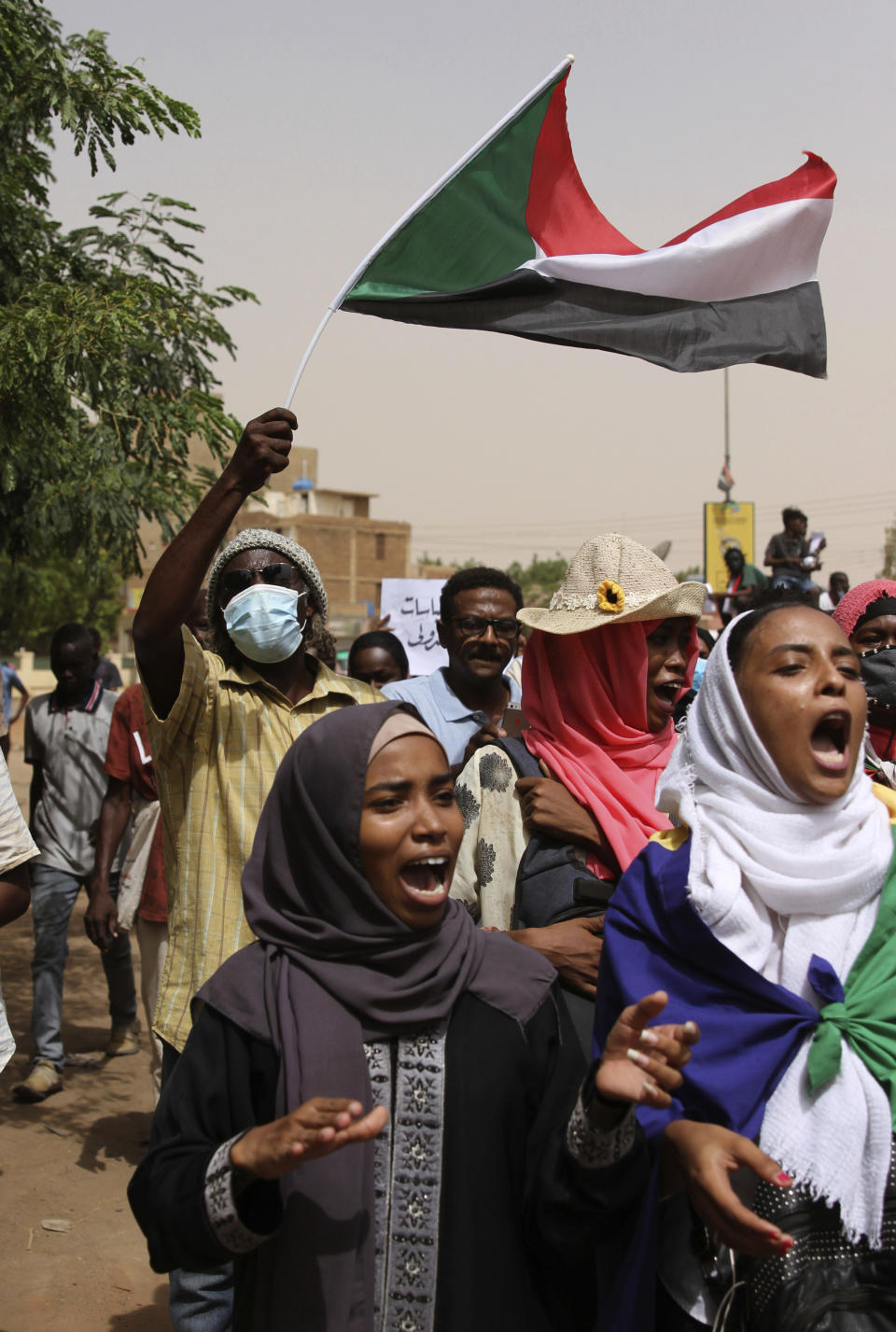 Sudanese take part in a protest over economic conditions, in Khartoum, Sudan, Wednesday, June 30, 2021. The World Bank and the International Monetary Fund said in a joint statement Tuesday, that Sudan has met the initial criteria for over $50 billion in foreign debt relief, another step for the East African nation to rejoin the international community after nearly three decades of isolation. (AP Photo/Marwan Ali)