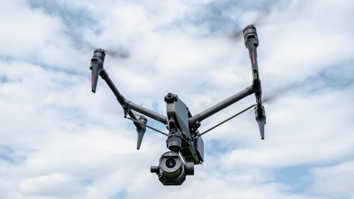  DJI Inspire 3 drone in flight against a intermittent cloudy sky 