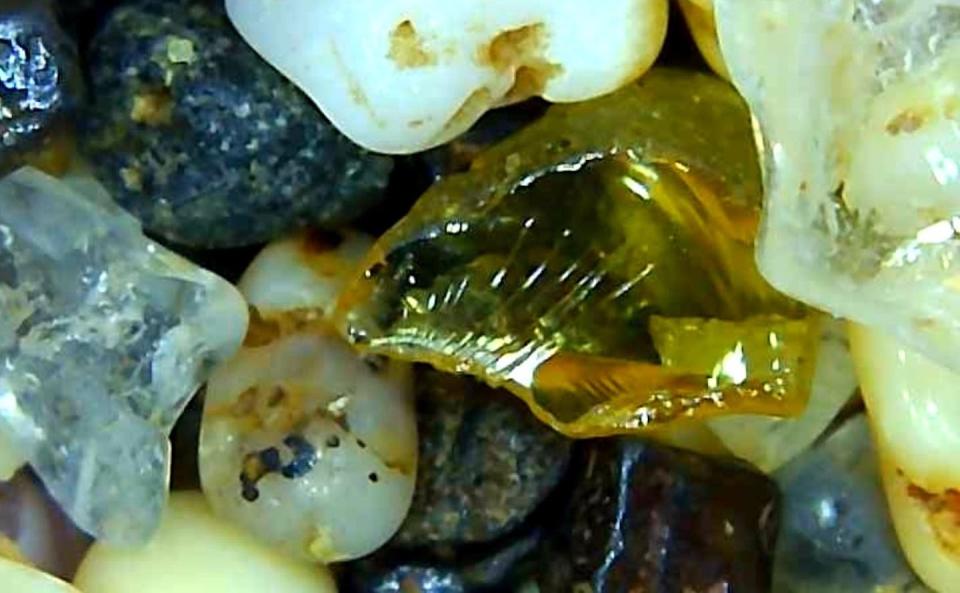 The yellowish piece of glass pictured in the center has a conchoidal fracture common for quartz. Lori Weeden