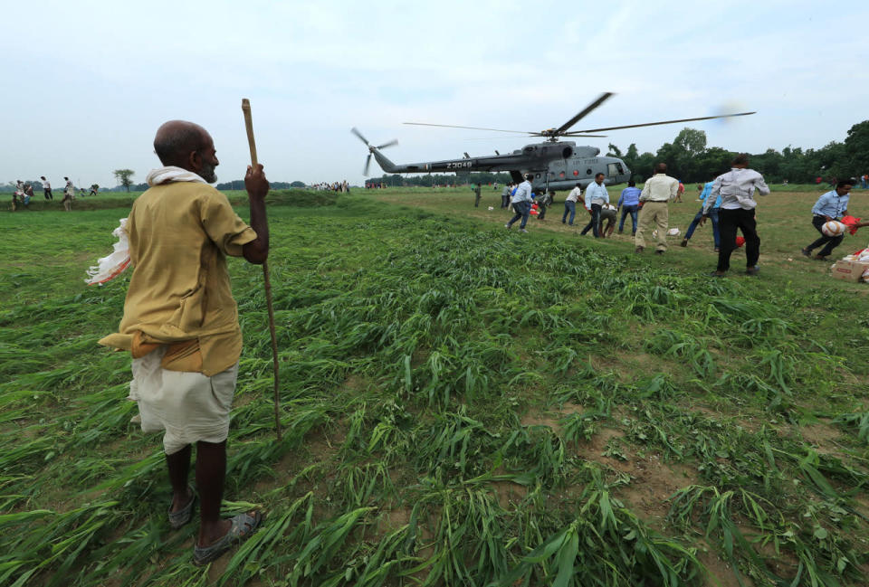 <p>An elderly man looks at the Indian Air Force helicopter as it lands with relief material in a field on the outskirts of Allahabad, India, Friday, Aug. 26, 2016. (AP Photo/Rajesh Kumar Singh)</p>