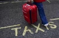 A traveller walks over a "Taxi" sign on the road outside Victoria Coach Station in central London, Britain October 28, 2016. REUTERS/Toby Melville