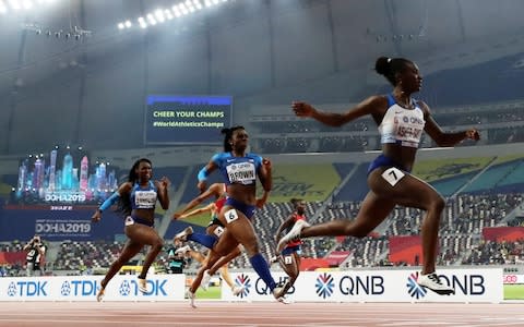 Dina Asher-Smith crosses the line victorious in Doha - Credit: Reuters