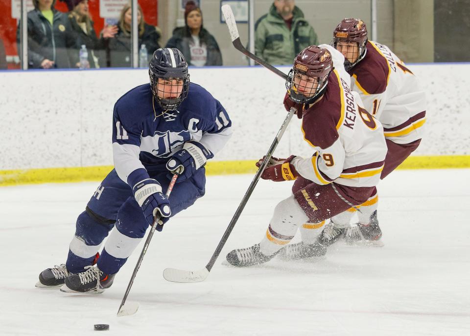 Hudson's Ty Koerbel controls the puck during the Explorers' Division I district quarterfinal game against Walsh Jesuit Wednesday at the Kent State Ice Arena.