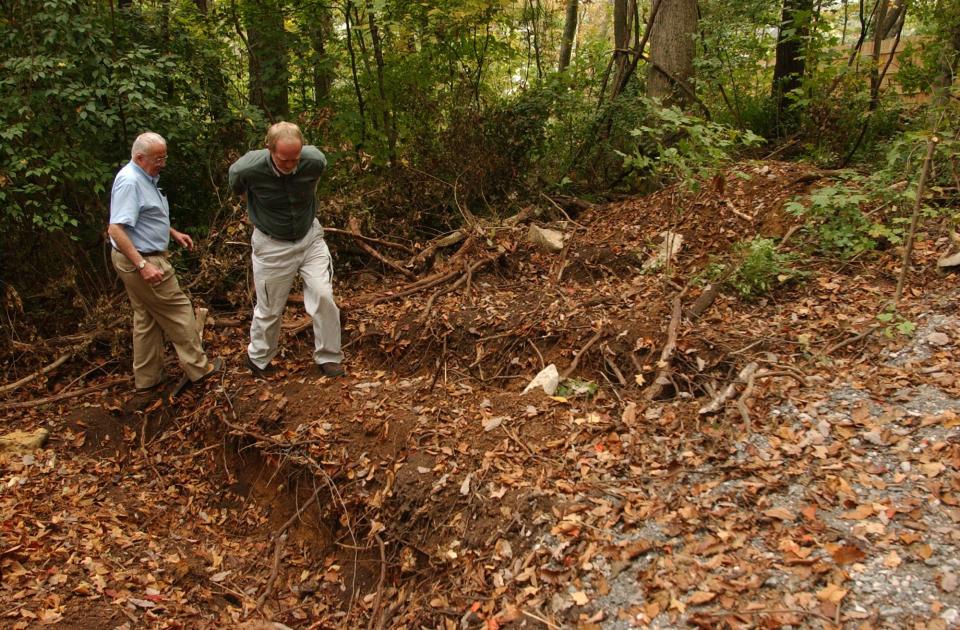 Writer Jon Jefferson and William M. Bass, Professor Emeritus at the University of Tennessee Department of Anthropology and founder of the body farm, walk through the outdoor research facility in 2003. The two have collaborated on a crime fiction series set at the body farm.