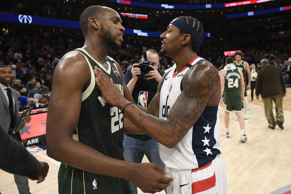 Washington Wizards guard Bradley Beal, right, meets with Milwaukee Bucks forward Khris Middleton (22) after an NBA basketball game, Monday, Feb. 24, 2020, in Washington. (AP Photo/Nick Wass)