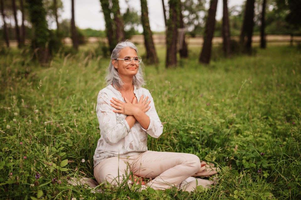 Woman sitting outside and meditating 