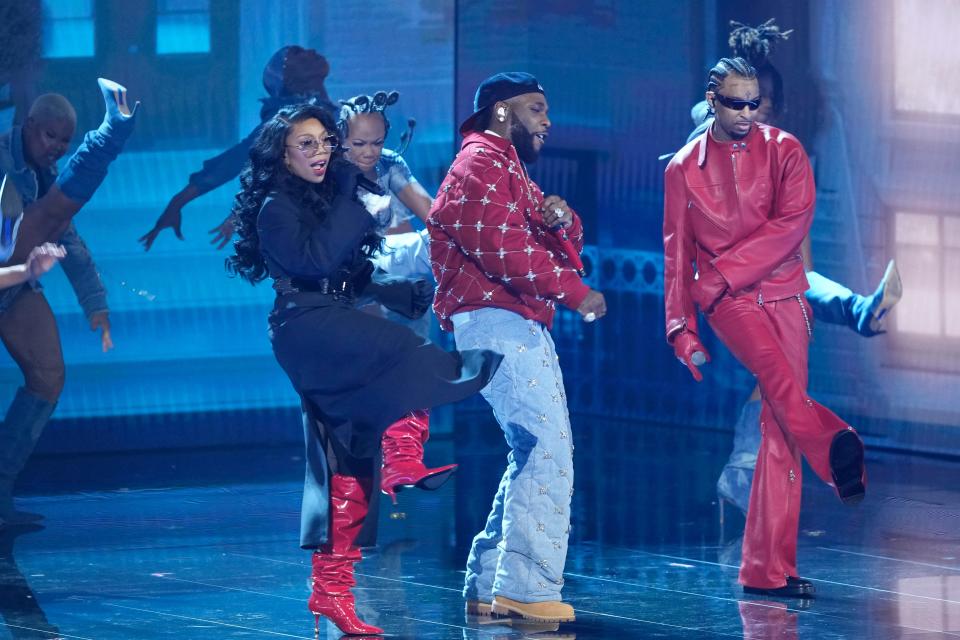 Burna Boy (center) performs with Brandy (left) and 21 Savage (right) during the 66th Annual Grammy Awards.