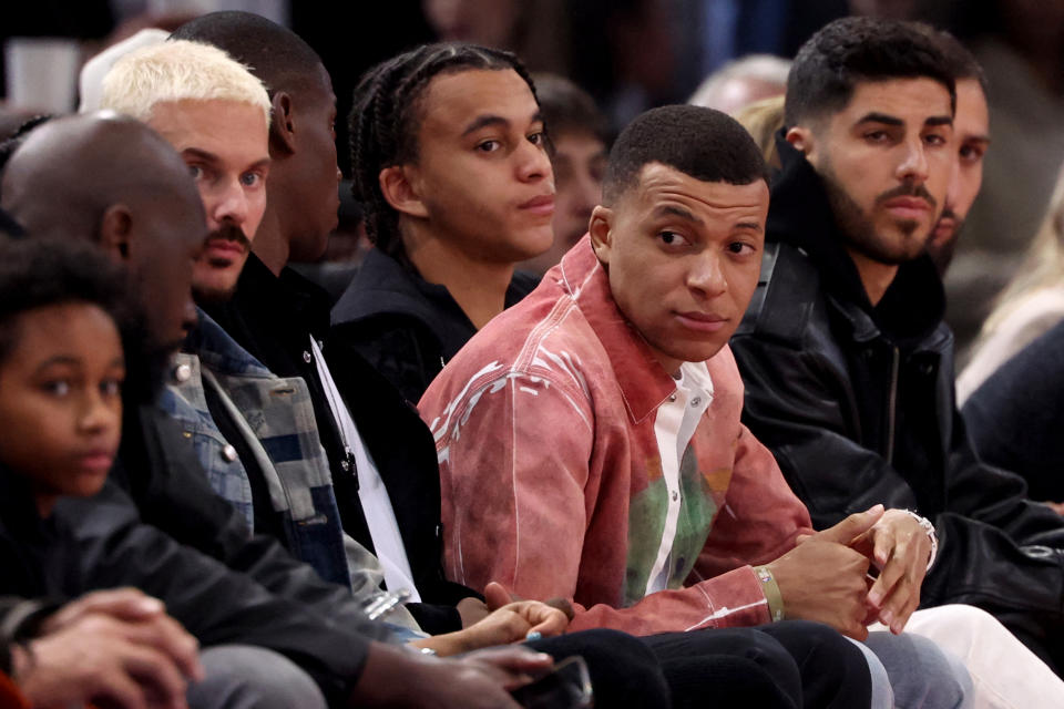 TOPSHOT - French singer M Pokora (L) and Paris Saint-Germain's football players (From L) Ethan Mbappe, Kylian Mbappe and Marco Asensio attend the NBA regular season basketball match between the Cleveland Cavaliers and the Brooklyn Nets at the Accor Arena in Paris on January 11, 2024. (Photo by EMMANUEL DUNAND / AFP) (Photo by EMMANUEL DUNAND/AFP via Getty Images)