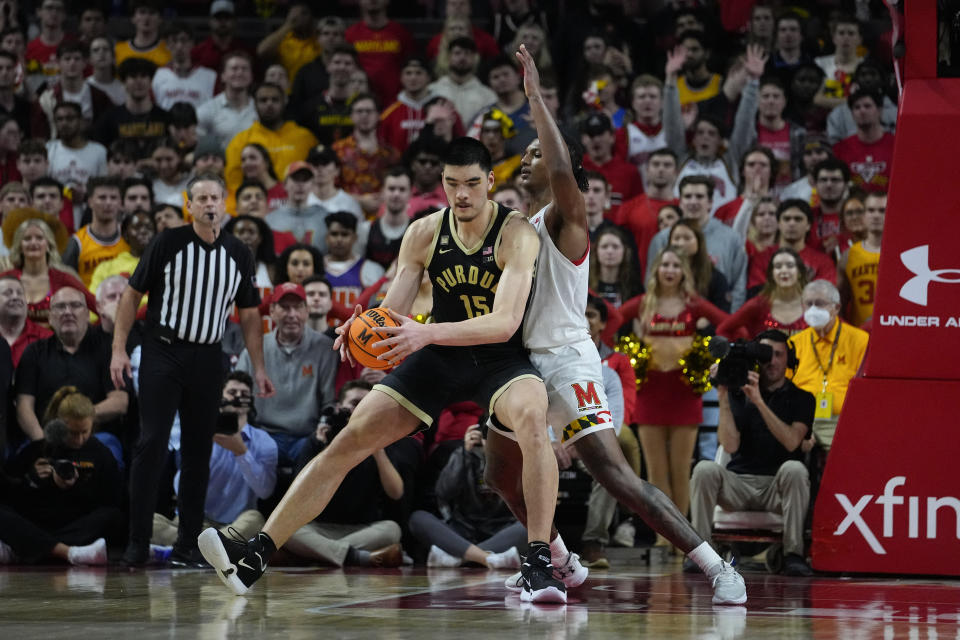 Purdue center Zach Edey, left, works his way toward the basket against Maryland forward Julian Reese during the second half of an NCAA college basketball game, Thursday, Feb. 16, 2023, in College Park, Md. Maryland won 68-54. (AP Photo/Julio Cortez)