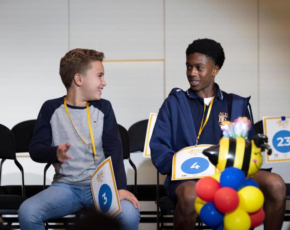 Orlando Bodes, from Archimedean Academy, left, smiles at James Reese, from Aventura City Of Excellence CS, after Reese placed third in the Miami Herald Miami-Dade/Monroe County Spelling Bee. Bodes went on to win second place. Alie Skowronski/askowronski@miamiherald.com