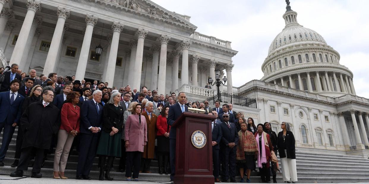 Members-elect of Congress stand on the steps of the US Capitol to honor the officers who lost their lives on January 6.