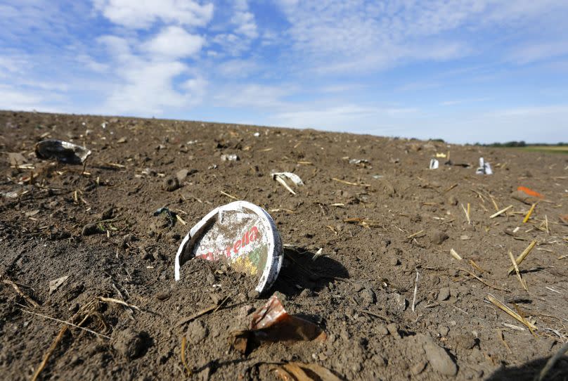 Plastic waste sits on a freshly cultivated field in Nauen, September 2018