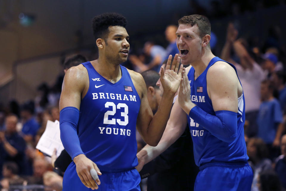 BYU forward Yoeli Childs (23) is greeted by Kolby Lee as he walks off the court during the second half of the team's NCAA college basketball game against Pepperdine on Saturday, Feb. 29, 2020, in Malibu, Calif. (AP Photo/Ringo H.W. Chiu)