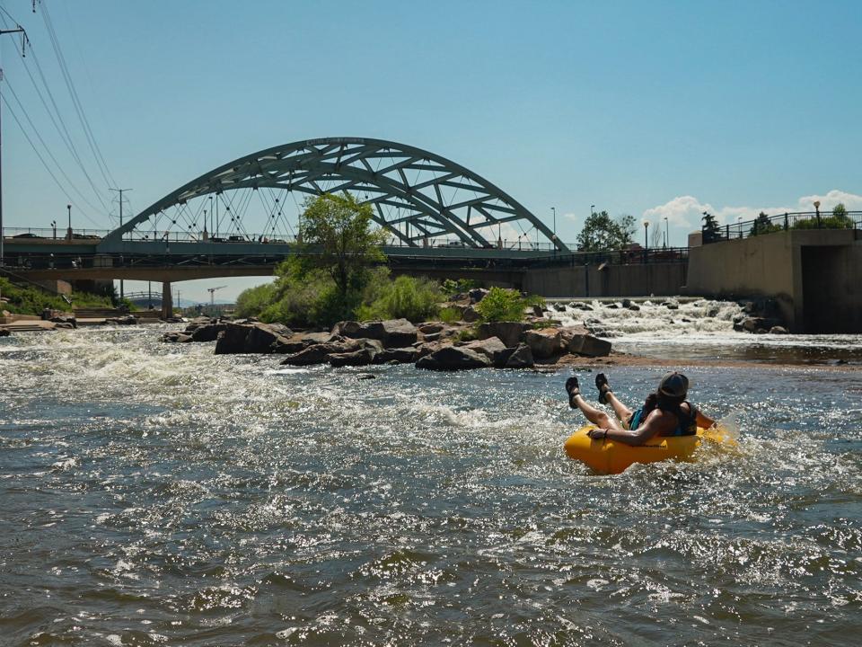 People cool off in the water at the confluence of the South Platte River and Cherry Creek in Denver, Monday, June 14, 2021.