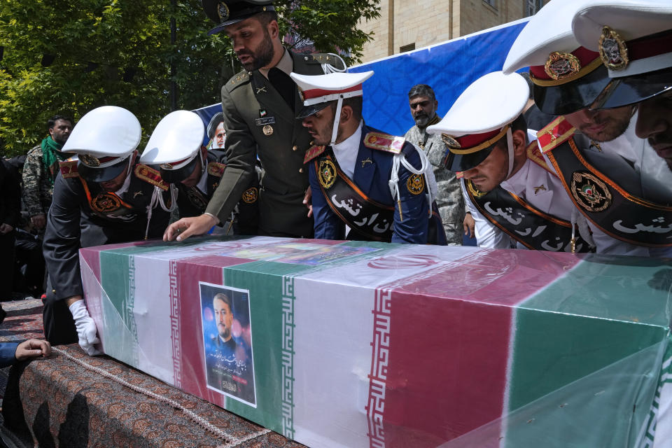 Army members place the flag-draped coffin of Iranian Foreign Minister Hossein Amirabdollahian, who was killed in a helicopter crash along with President Ebrahim Raisi on Sunday in a mountainous region of the country's northwest, on the stage during a funeral ceremony at the foreign ministry in Tehran, Iran, Thursday, May 23, 2024. The death of Raisi, Foreign Minister Hossein Amirabdollahian and six others in the crash on Sunday comes at a politically sensitive moment for Iran, both at home and abroad.(AP Photo/Vahid Salemi)