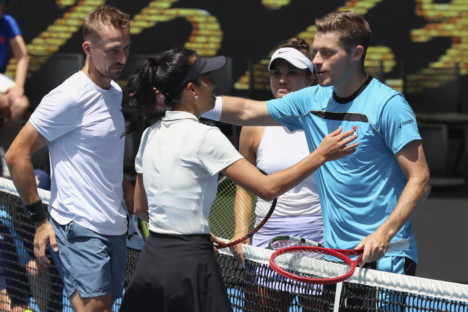 Hsieh Su-Wei of Taiwan and Jan Zielinski, left, of Poland are congratulated by Desirae Krawczyk of the U.S. and Neal Skupski, right, of Britain following the mixed doubles final match at the Australian Open tennis championships at Melbourne Park, Melbourne, Australia, Friday, Jan. 26, 2024. (AP Photo/Asanka Brendon Ratnayake)